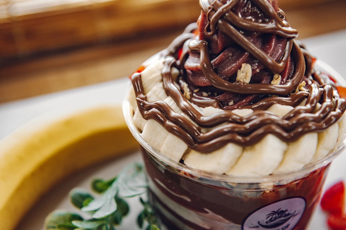 Close-up of açaí, banana and a rich chocolate drizzle